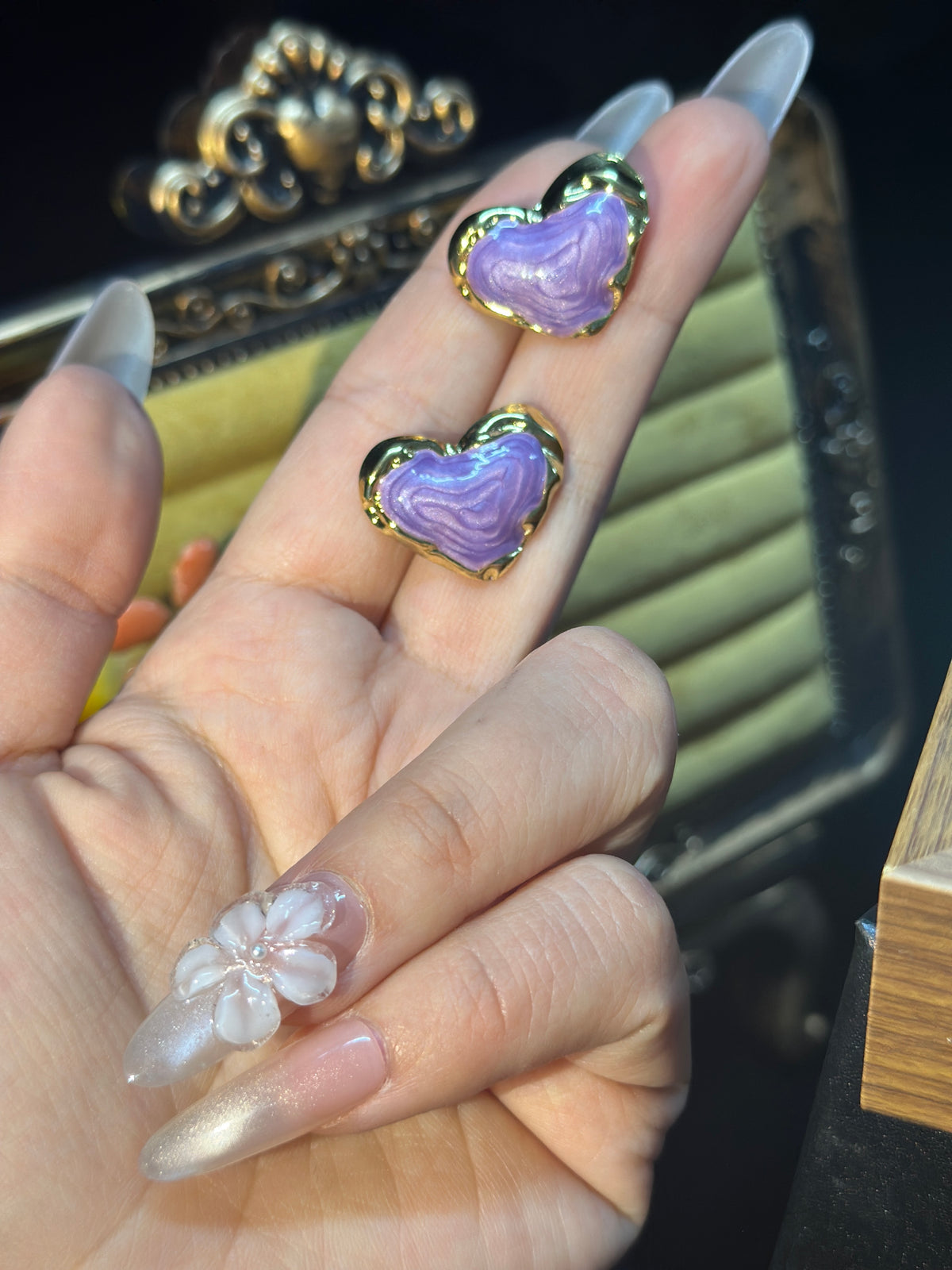 Lavender sculptural heart stud earrings with flowing textured purple centres and polished gold-tone borders