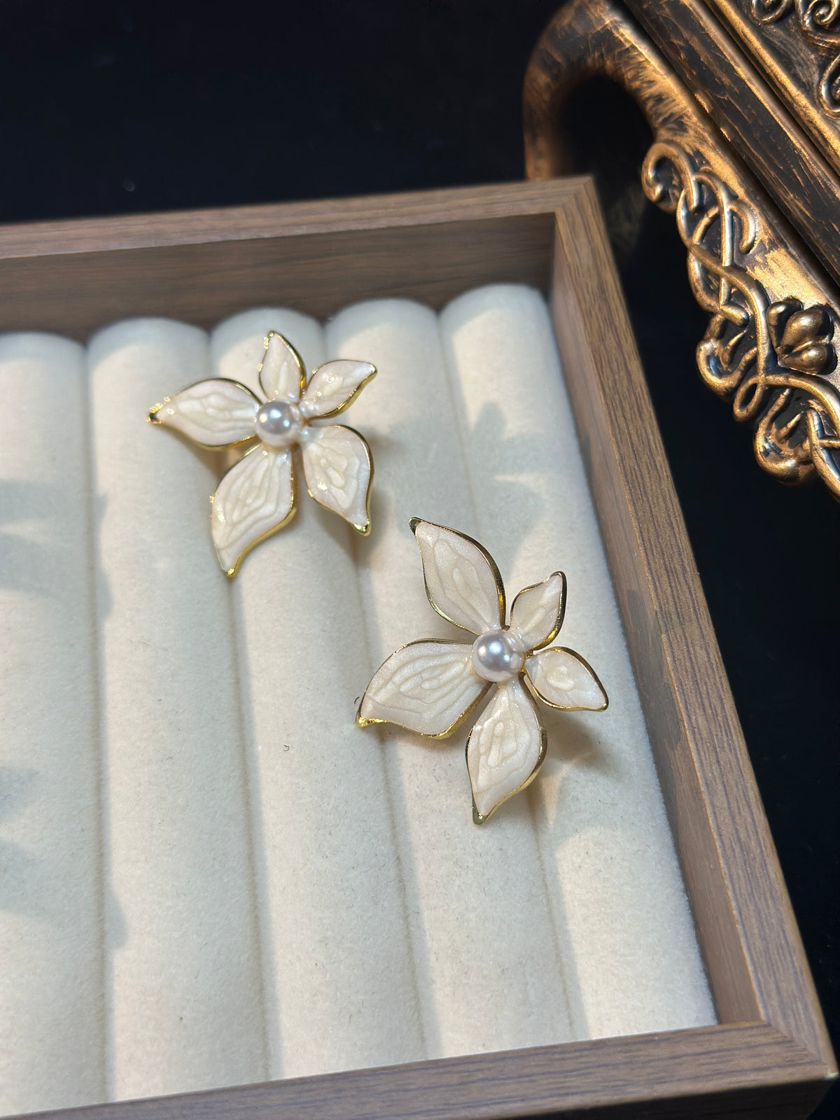 Ivory white pearl flower stud earrings with five textured pearlescent petals, gold-tone outlines and pearl-style centres