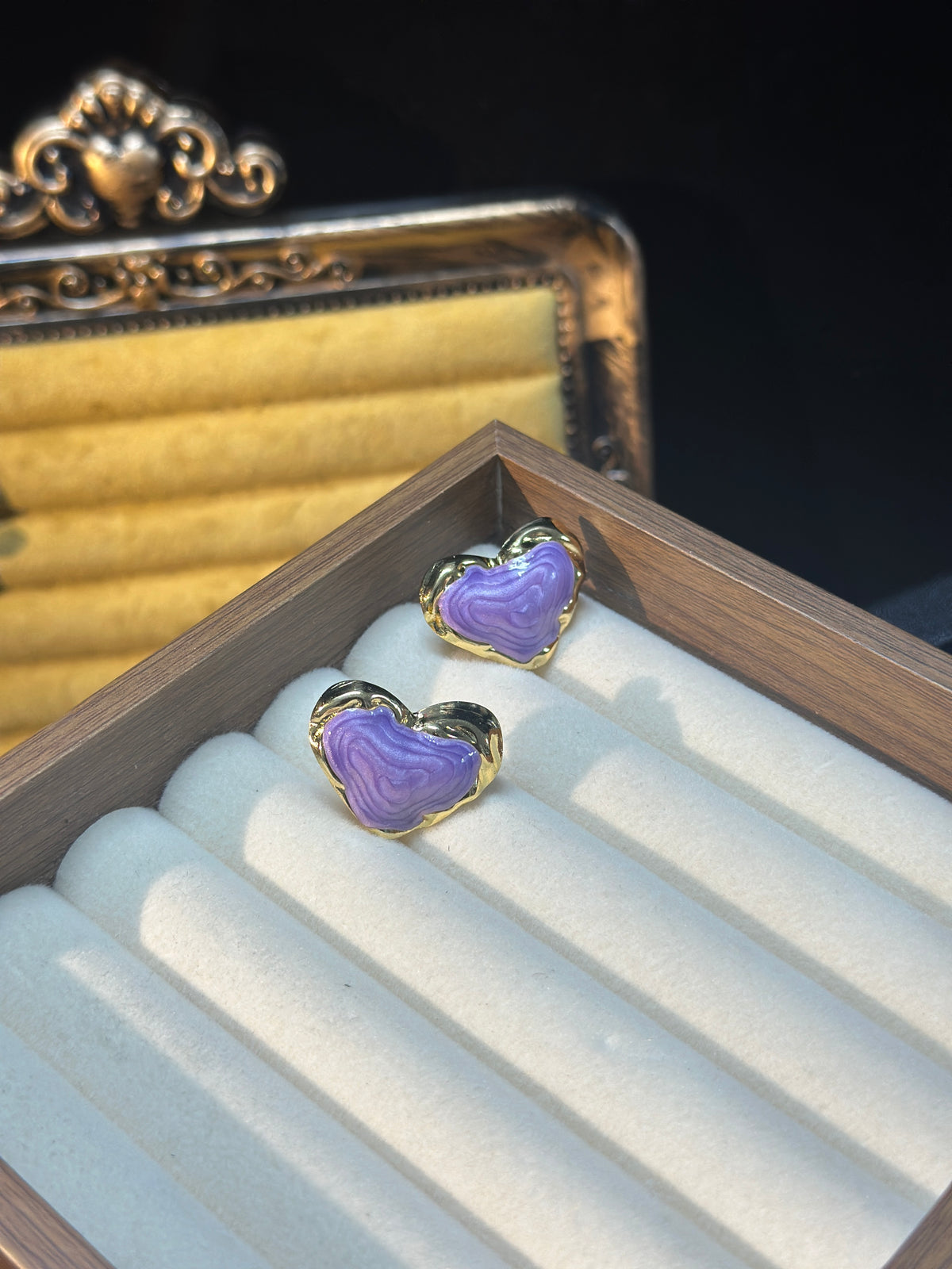 Lavender sculptural heart stud earrings with flowing textured purple centres and polished gold-tone borders