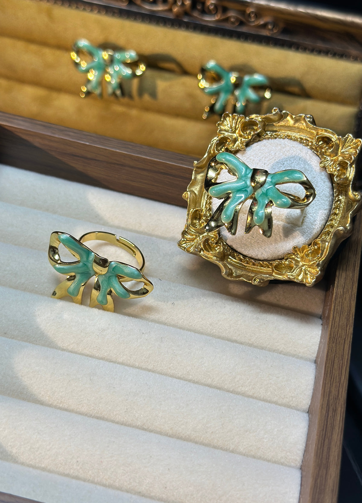 Mint green bow adjustable ring with glossy enamel-style detailing and an openwork gold-tone outline