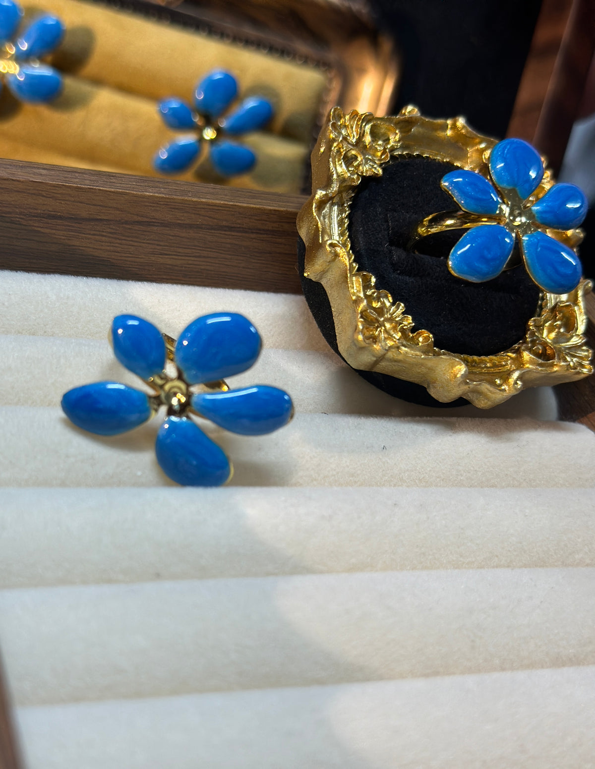Royal blue five-petal flower adjustable ring with glossy blue petals and ornate gold-tone setting