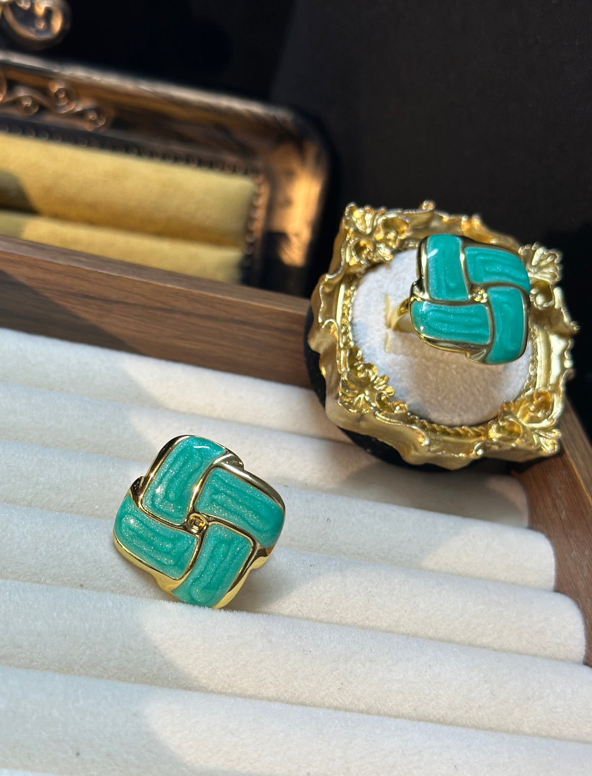 Teal green geometric adjustable ring with glossy teal accents, rounded gold-tone elements and ornate decorative setting