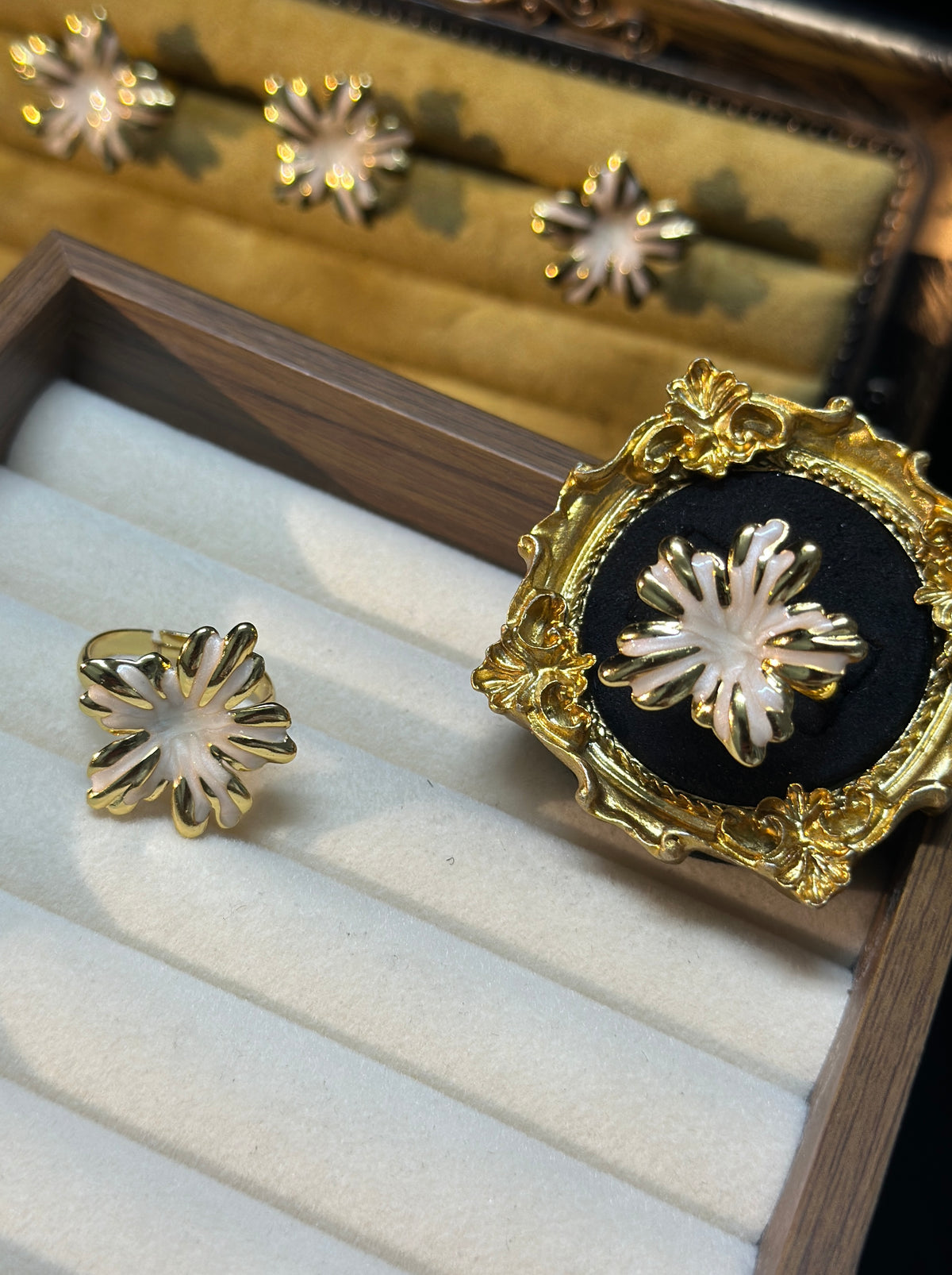 Pearl white sunburst flower adjustable ring with pearlescent petals and gold-tone outlines