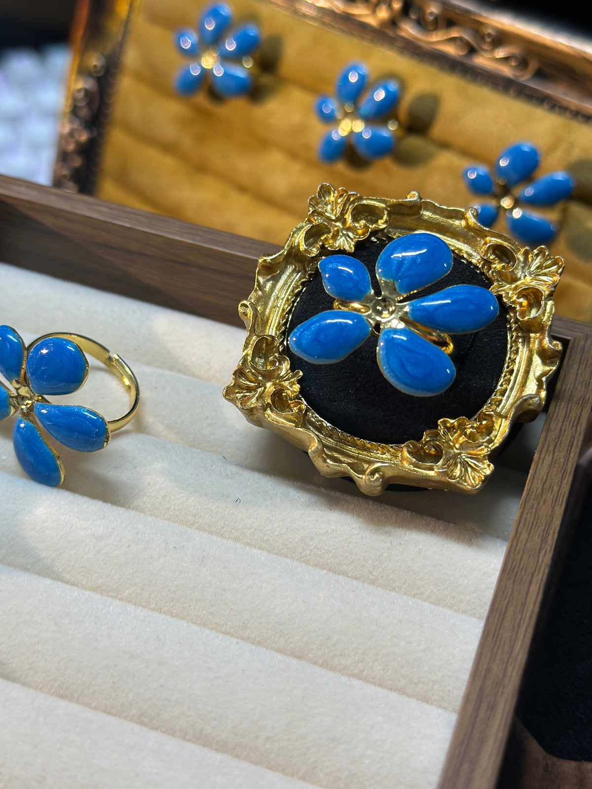 Royal blue five-petal flower adjustable ring with glossy blue petals and ornate gold-tone setting