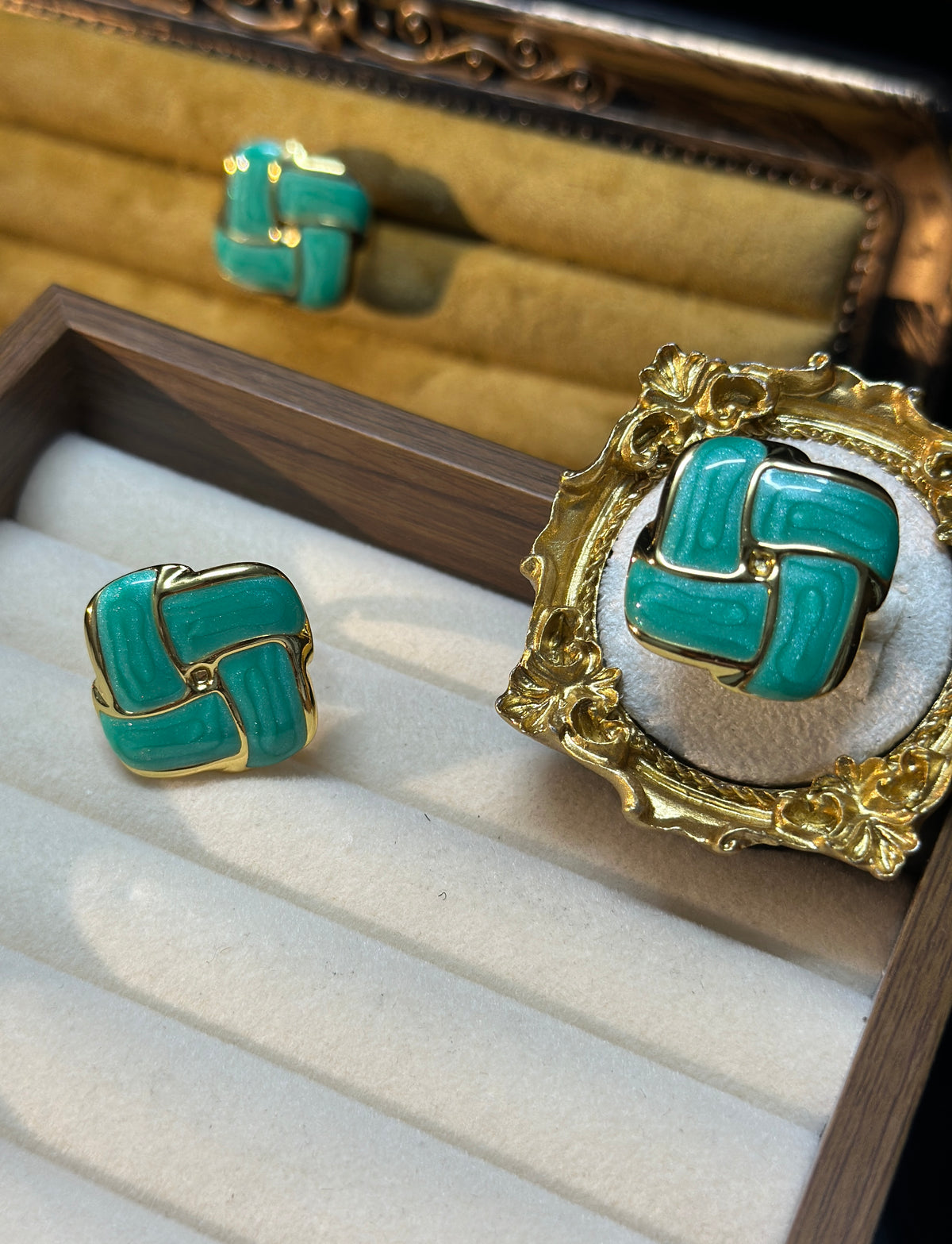 Teal green geometric adjustable ring with glossy teal accents, rounded gold-tone elements and ornate decorative setting