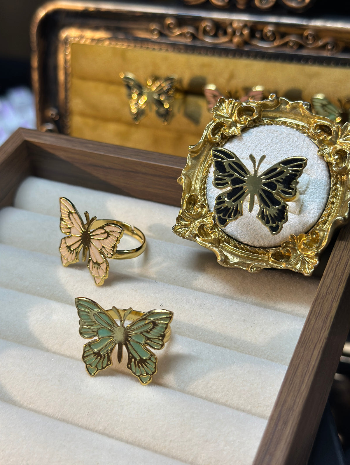 Butterfly adjustable ring with detailed wings and gold-tone outline, three colors available. 