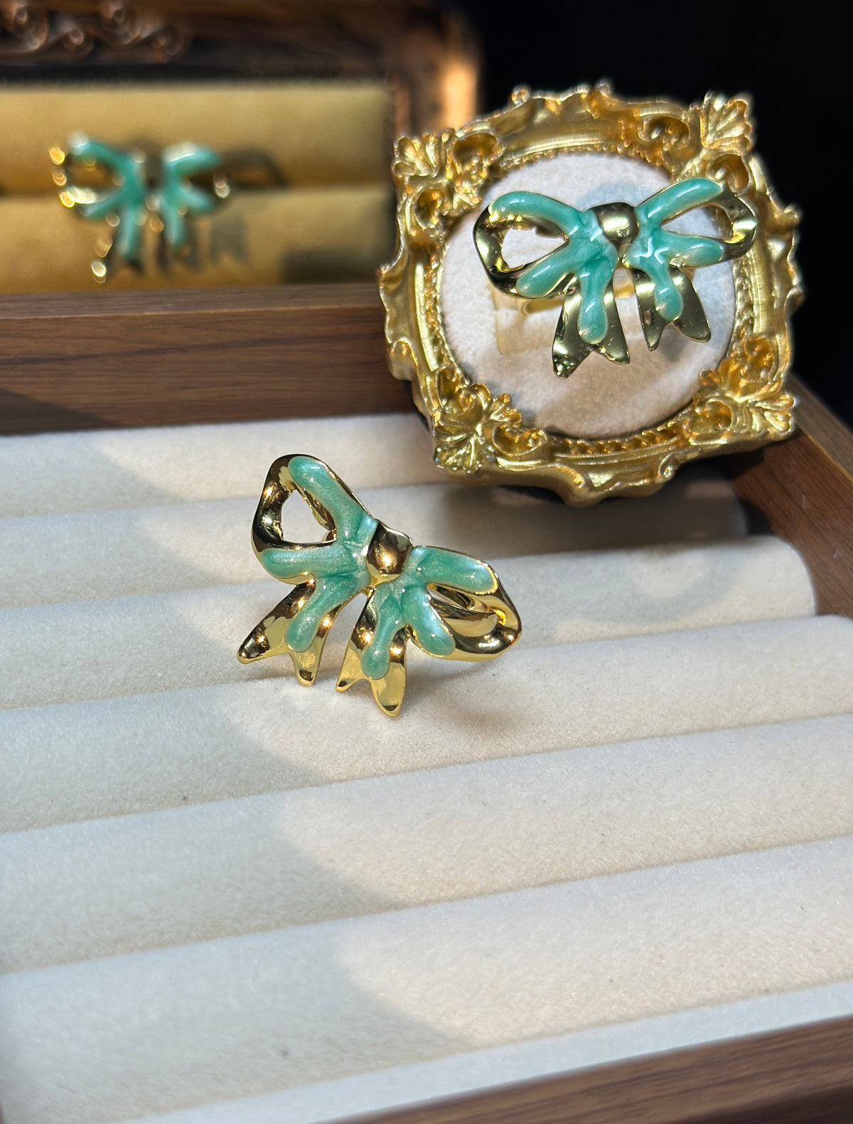 Mint green bow adjustable ring with glossy enamel-style detailing and an openwork gold-tone outline