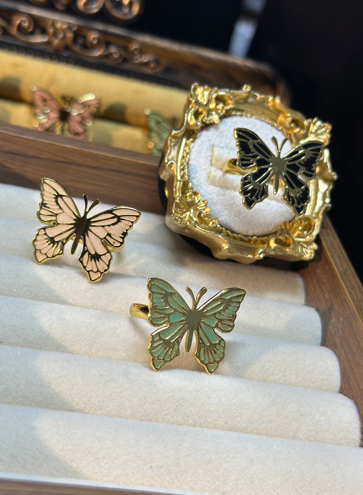 Butterfly adjustable ring with detailed wings and gold-tone outline, three colors available. 
