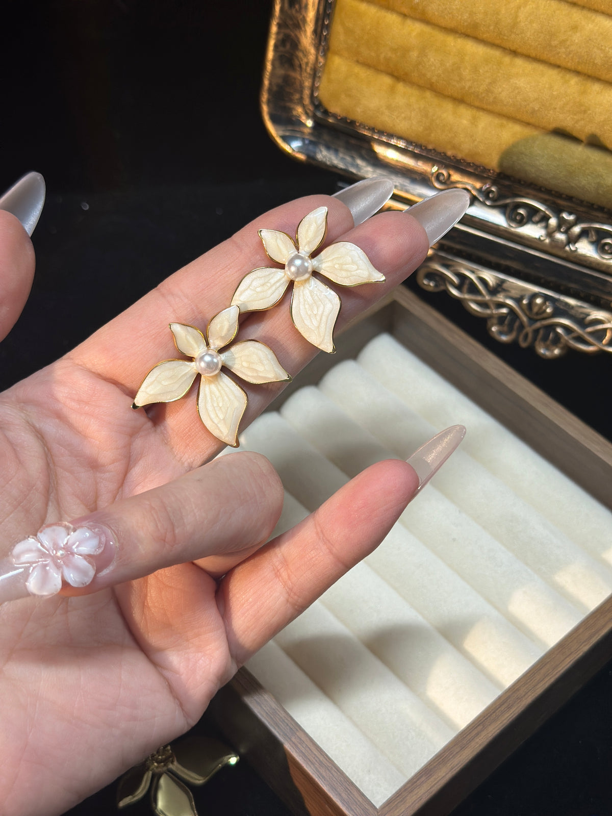 Ivory white pearl flower stud earrings with five textured pearlescent petals, gold-tone outlines and pearl-style centres