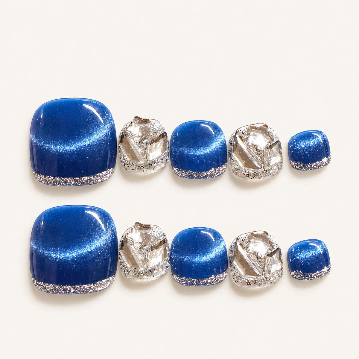 Blue cat-eye handmade press-on toenails with sparkling silver glitter edges and dimensional silver crystal-style embellishments