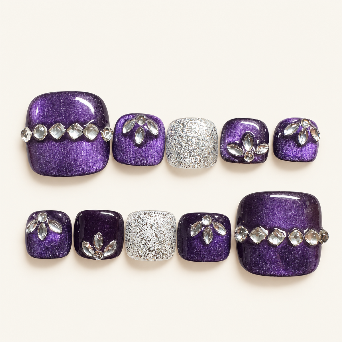 Purple cat-eye handmade press-on toenails with silver glitter accents and crystal floral embellishments
