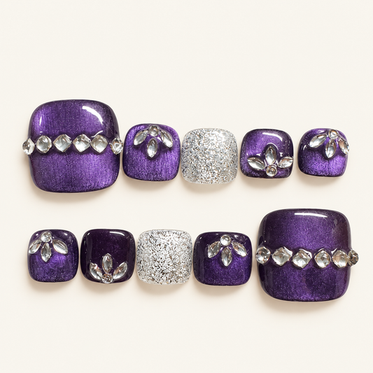 Purple cat-eye handmade press-on toenails with silver glitter accents and crystal floral embellishments